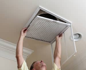 Air handler reaching over to open up an air vent